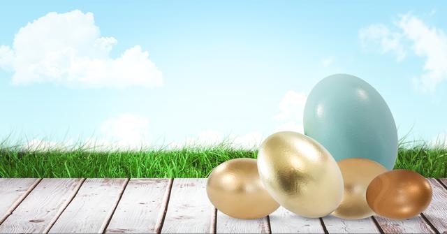 Charming scene featuring golden and pastel-colored Easter eggs resting on a wooden deck against a bright blue sky with fluffy clouds and lush green grass. Ideal for use in holiday greeting cards, festive marketing materials, Easter-themed backgrounds, and social media posts celebrating the season of renewal.