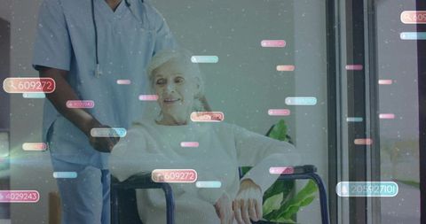 Nurse pushing senior woman in wheelchair by window with floating digital health data tags