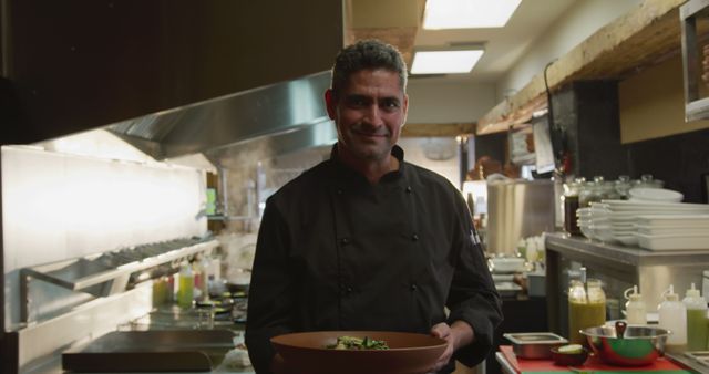 Smiling Chef Holding Dish in Commercial Kitchen - Download Free Stock Images Pikwizard.com