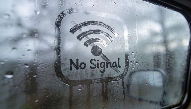 No signal wi-fi icon on fogged car window with raindrops conveying connectivity loss
