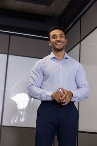 Confident Professional Delivering Corporate Presentation in Modern Office