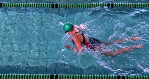 Athletic Swimmer Practicing Breaststroke in Indoor Pool