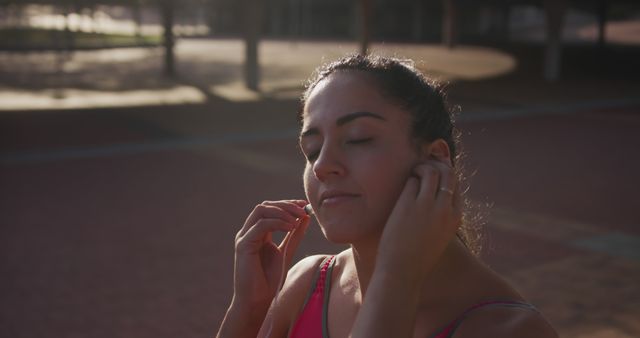 Young woman ready for fitness outdoor wearing earphones - Download Free Stock Images Pikwizard.com