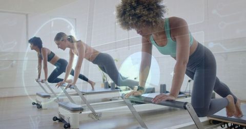 Women exercising on pilates reformers with futuristic hud overlay