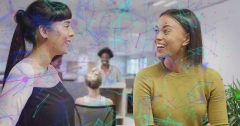 Professional women exchanging ideas in modern office environment