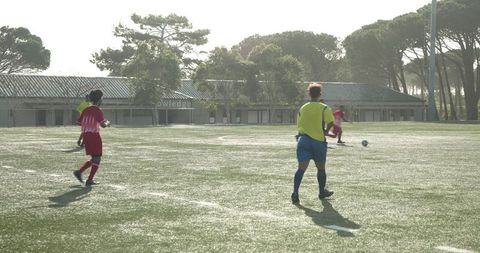 Soccer Players Preparing for Intense Match on Green Field