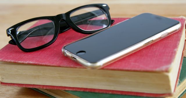 Close-Up of Glasses and Smartphone on Books - Download Free Stock Images Pikwizard.com