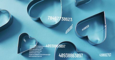 Resting metal heart cookie cutters featuring floating numeric overlays on blue flatlay