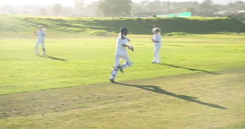 Female Cricketer Running Enthusiastically on Sunny Field