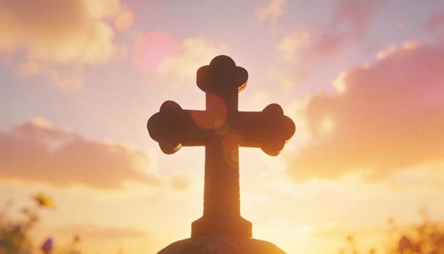 Ornamental trefoil cross silhouette at golden sunrise with lens flare, spiritual memorial