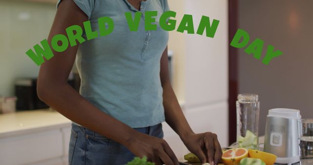 Image of world vegan day text over african american woman cutting vegetables. Global ecology and digital interface concept digitally generated image.