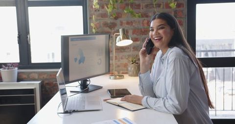 Professional Woman Reviewing Business Data at Modern Office Desk