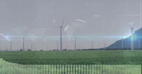Futuristic wind turbines in lush field with digital technology overlay