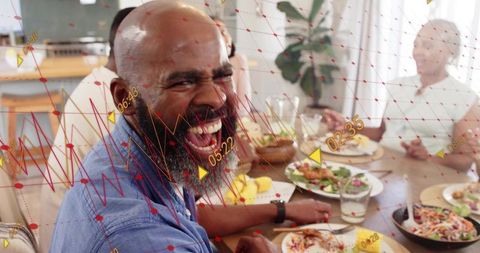 Laughing bearded man enjoying family meal with augmented reality overlay