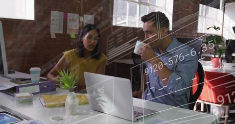 Colleagues Collaborate Reviewing Data in Modern Loft Office