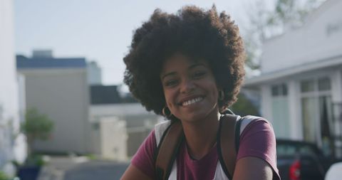 urban portrait of smiling woman with curly hair - Download Free Stock Images Pikwizard.com