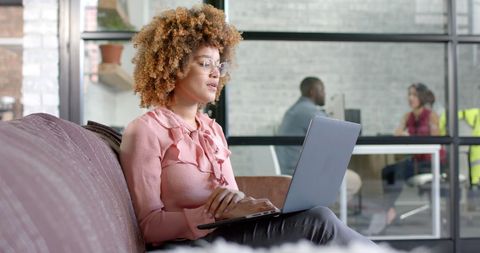 Focused African American Businesswoman Working on Laptop in Modern Office