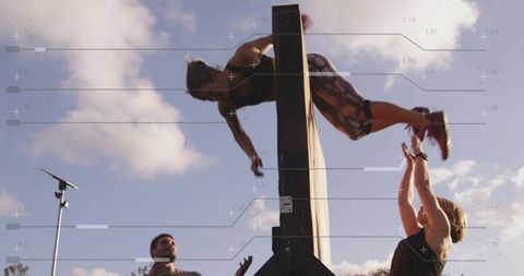 Female Athlete Overcoming Obstacle Wall in Outdoor Training