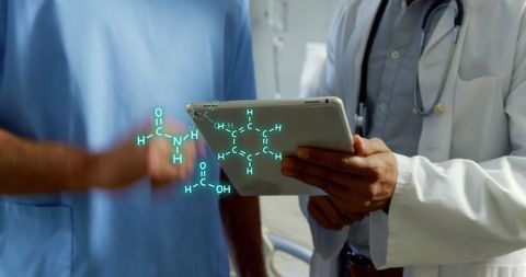 Doctors Analyzing Digital Chemical Structure on Tablet