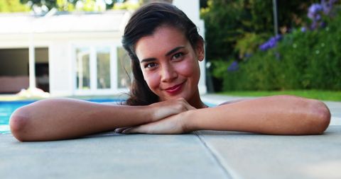 Smiling Woman Relaxing by Poolside Enjoying Sunny Day