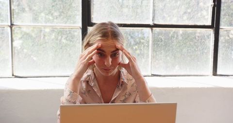 Stressed businesswoman facing deadlines at office desk