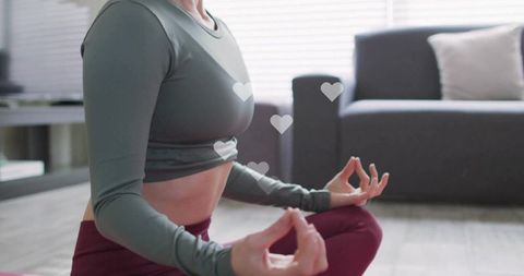 Woman practicing meditation at home in comfortable attire