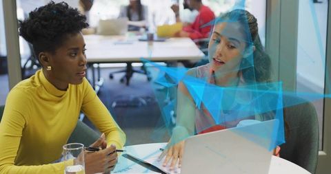 Two Women Collaborating on Business Innovation with Augmented Reality Graphics