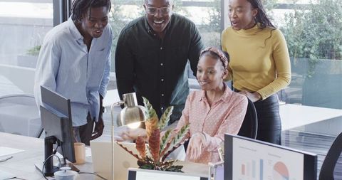 Team Celebrating Success Together in Modern Office