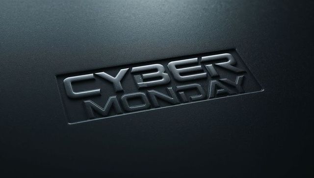 Embossed metallic cyber monday text on dark blue textured surface with reflective finish