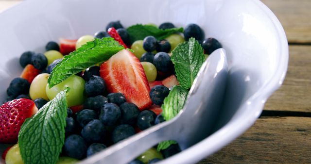 Fresh Fruit Salad with Mint Leaves in White Bowl - Download Free Stock Images Pikwizard.com