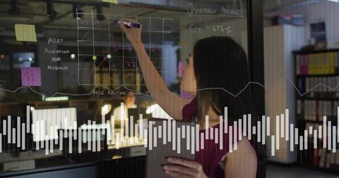 Professional Analyzing Data Trends on Transparent Board in Office