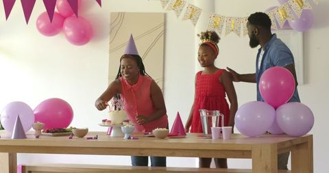 Mother and Daughter Celebrating Birthday at Home with Cake