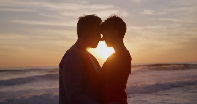 Romantic senior caucasian couple embracing by sea silhouetted at sunset, copy space. Togetherness, relationship, romance, retirement, vacations, wellbeing and active senior lifestyle, unaltered.