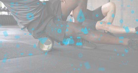 Partners rolling with foam roller on gym floor for mobility recovery and conditioning