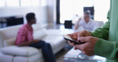 Asian Executive Using Phone in Modern Office Environment