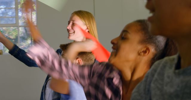 Group of Friends Cheering and Having Fun in Bright Room - Download Free Stock Images Pikwizard.com