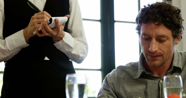 Waiter Taking Order from Male Customer at Restaurant Table - Download Free Stock Images Pikwizard.com