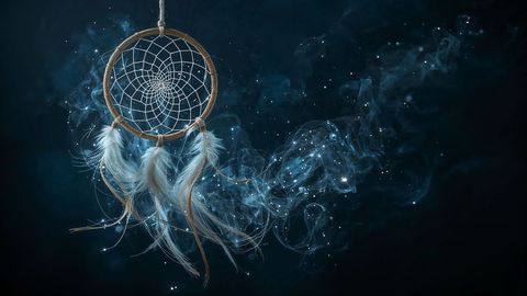 Evocative dreamcatcher with white feathers and ethereal mist