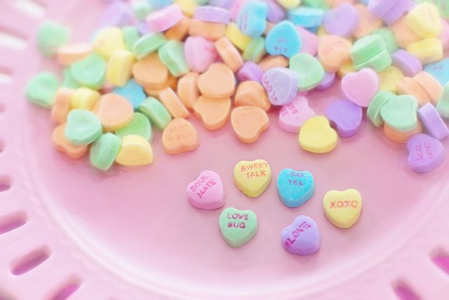Colorful Candy Hearts with Romantic Messages on Pink Background - Download Free Stock Photos Pikwizard.com