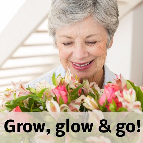 Joyful senior woman holding colorful flowers smiling