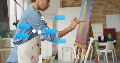 Black woman painter creating new art in studio with speech bubbles