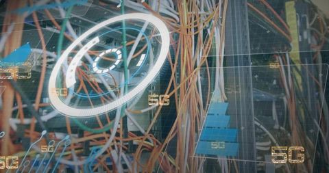 Orange yellow network cables snaking through rack with blue patch modules and 5g overlay
