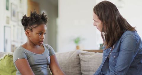 Mother in Disagreement with Young Daughter in Living Room