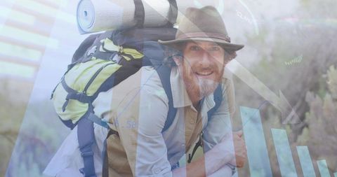 Smiling male hiker resting on trail carrying large backpack and hat, outdoor adventure