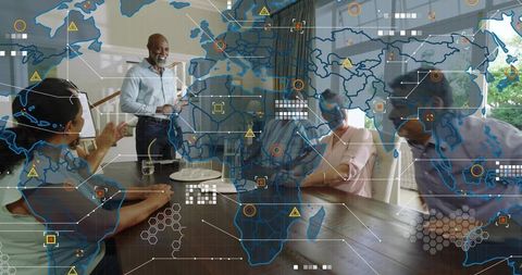 Senior executive presenting global strategy to diverse team at table with world map overlay