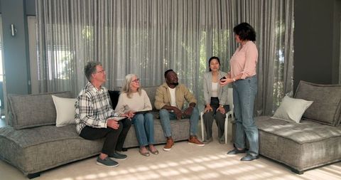 Diverse group therapy session with therapist and patients