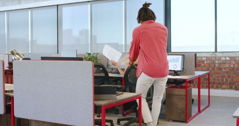 Colleagues engaging in playful chair ride in open office