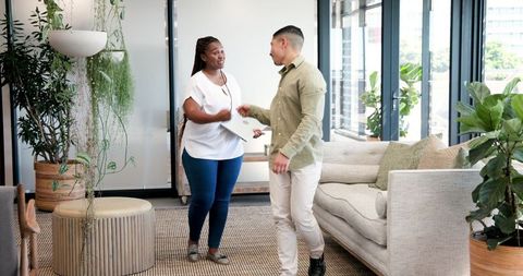 Co-workers collaborating in modern office lounge