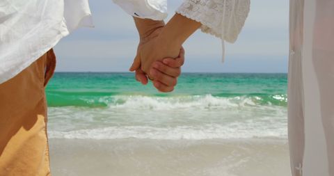 Romantic Couple Holding Hands on a Beach Vacation