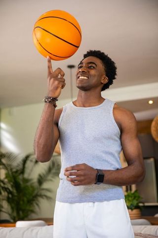 Dynamic athlete spin basketball leisure with smartwatch indoor